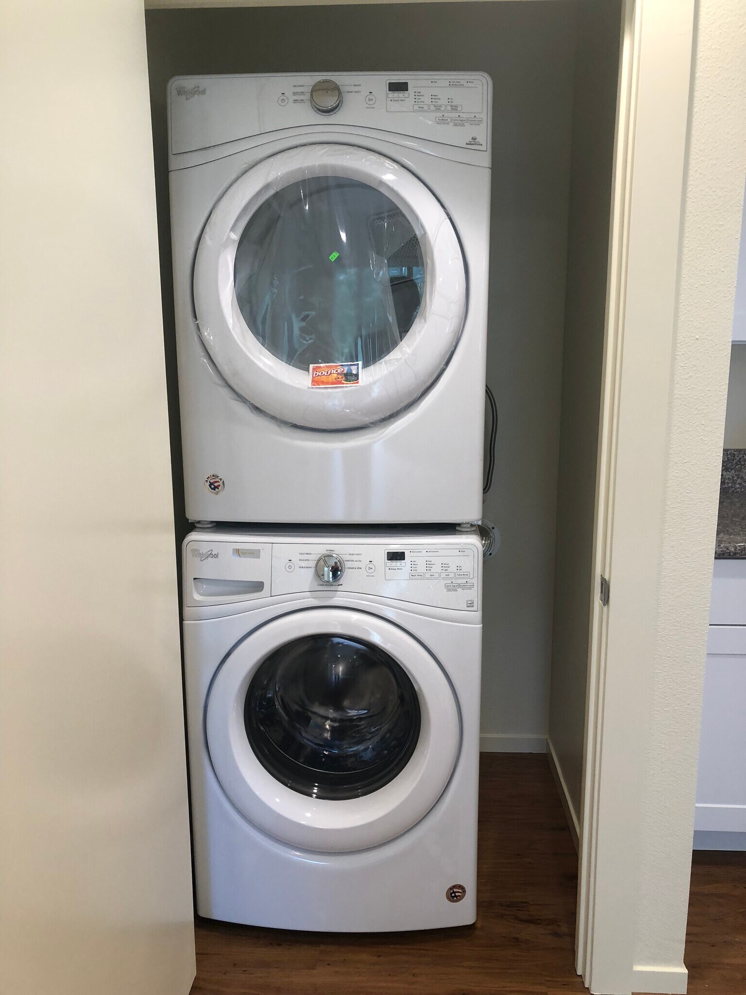Stacked washer and dryer in closet with door; room for brooms, mops, etc. - 2362 Meadow st