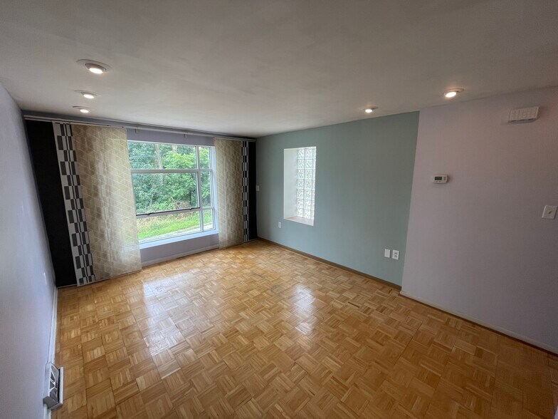 Living room with dimmable recessed lights and sliding panel blinds - 227 Wilbert St
