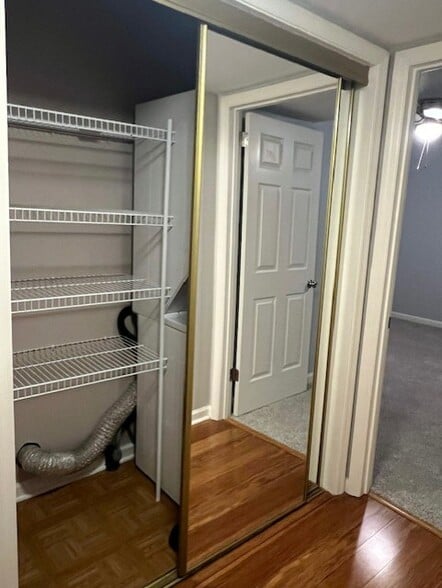 Shelving next to the stackable washer and dryer. - 5714 Brentwood Trce