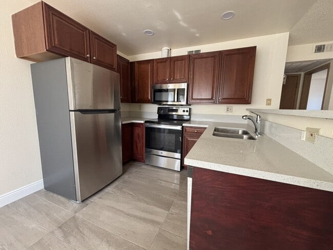 Building Photo - Downstairs 2BR/1BA—recently updated with new flooring, new countertops, and clean, neutral finishes.