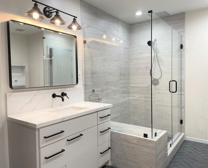 Updated bath with separate his and hers vanity, and large walk-in shower - 505 Bastrop St
