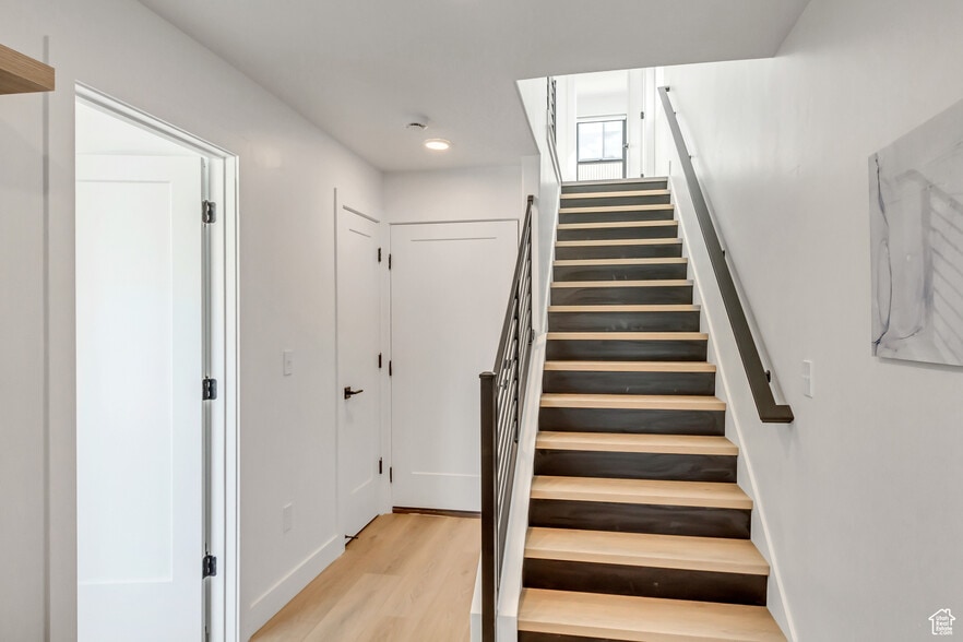Stairway featuring wood finished floors and baseboards - 44 W Iko Ave
