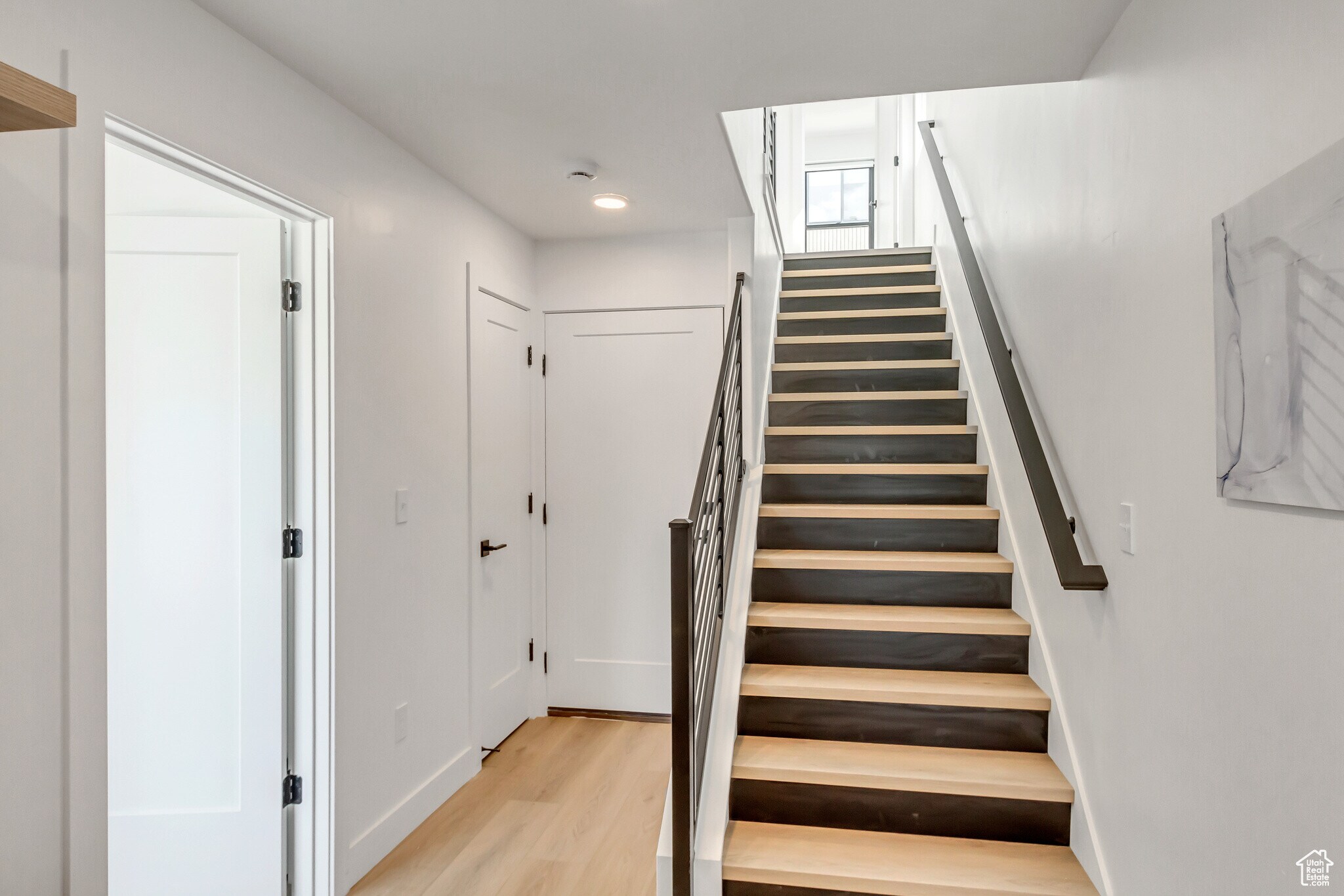 Stairway featuring wood finished floors and baseboards - 44 W Iko Ave
