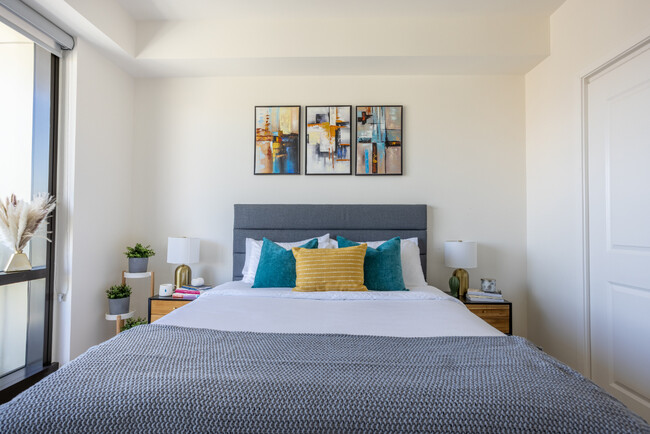 This stylish bedroom offers elegant decor and cozy furnishings for the perfect retreat - 400 S Broadway