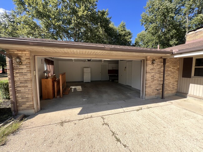 Two car garage with workbench, and extra fridge. - 1298 Cedarcliff Dr