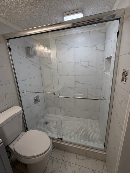 Tiled shower and glass doors. - 2301 Basil Dr
