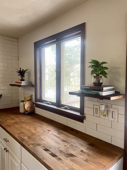 Butcher block countertops make up the kitchen space. - 186 Linwood St