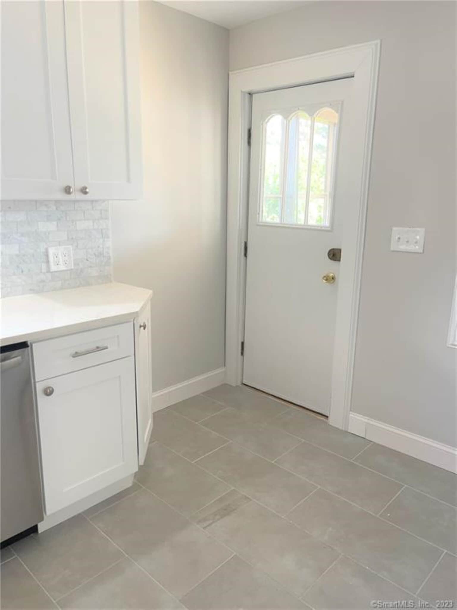 Kitchen walks out to screened in porch and rear fenced in yard - 10 Treadwell St