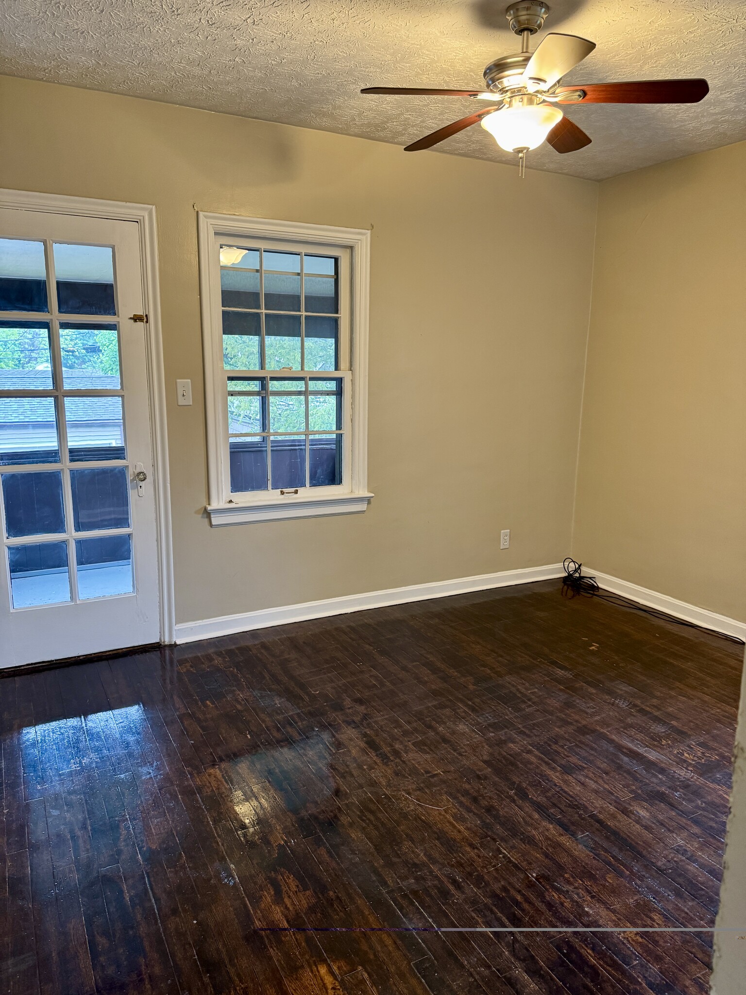 Comfortable bedroom with hardwood floors, natural light, and direct access to the enclosed three-sea - 3682 Glencairn Road