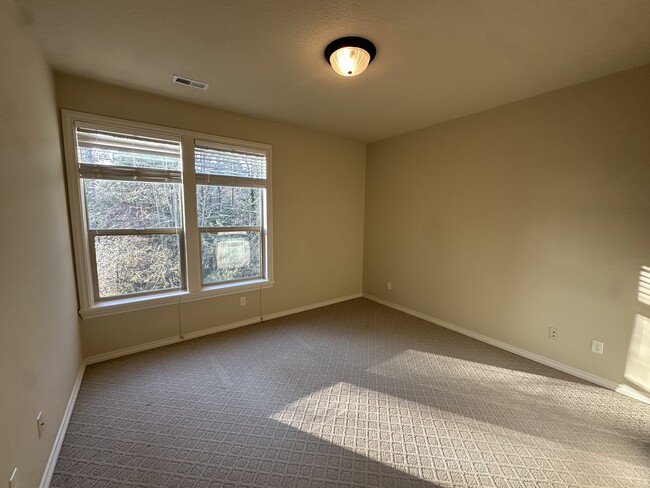 Bedroom with view towards creek/ nature area - 1404 SW Dickinson Ln