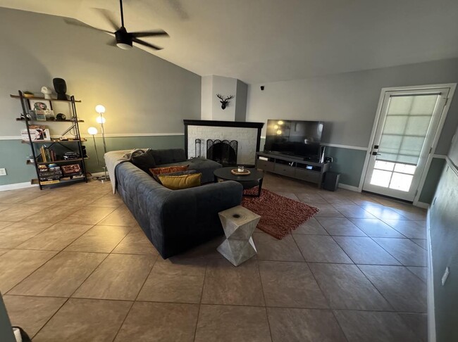 Living room + back door leading to the backyard - 9440 N 52nd Ln