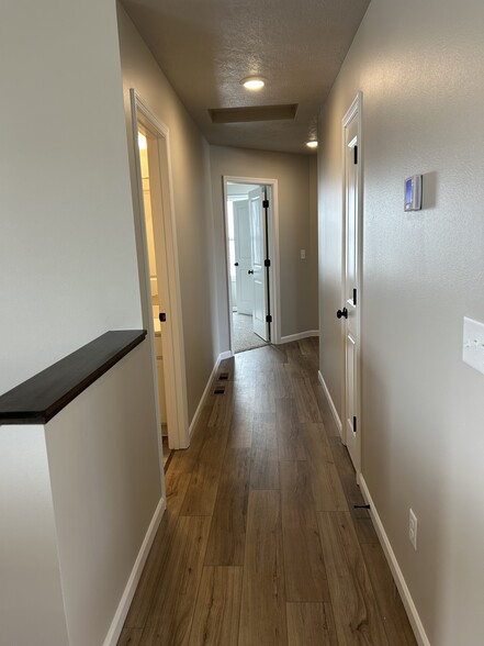 Hallway leading to bath, closet, 3 bedrooms - 5940 S Coneflower Ave