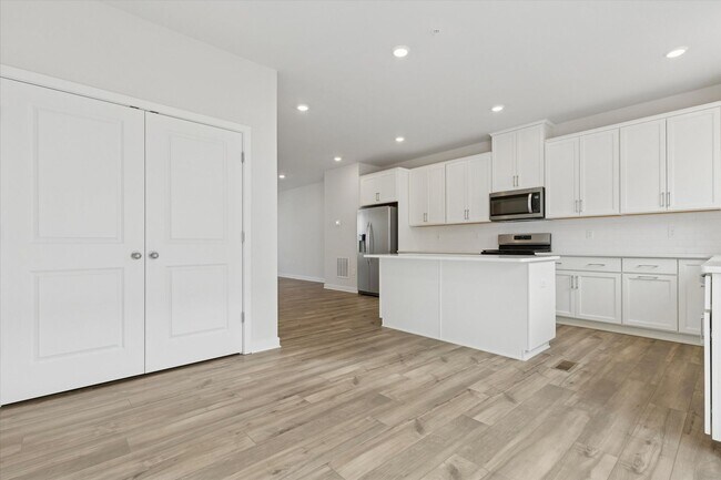 Building Photo - COMING SOON! Brand New River Pointe townhome with modern finishes, flexible living space, and a p...