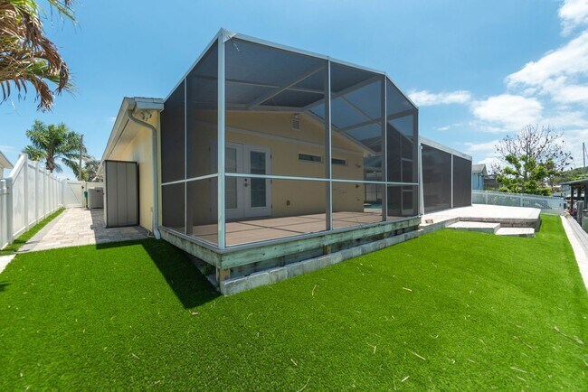 Building Photo - Live the ultimate Space Coast waterfront lifestyle at this stunning beachside canal home in Satel...