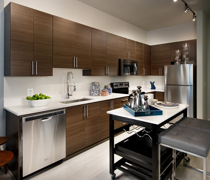 Open concept kitchen with granite countertops, European-style cabinetry, stainless-steel appliances and movable kitchen island - Avalon Dunn Loring