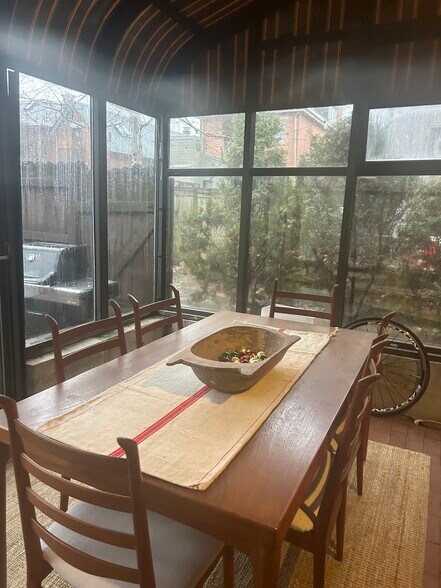 Enclosed porch with brick floor. Can be used as a green house. - 181 E Kossuth St