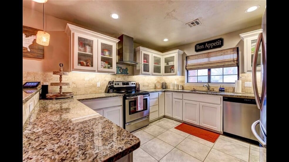 Spacious kitchen with granite countertops and stainless steel appliances - 2056 NW 48th St