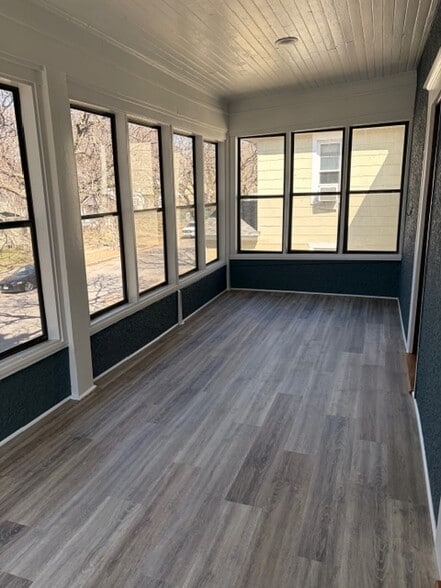 This fabulous three-season porch spans the entire width of the house. - 623 Pierce St NE