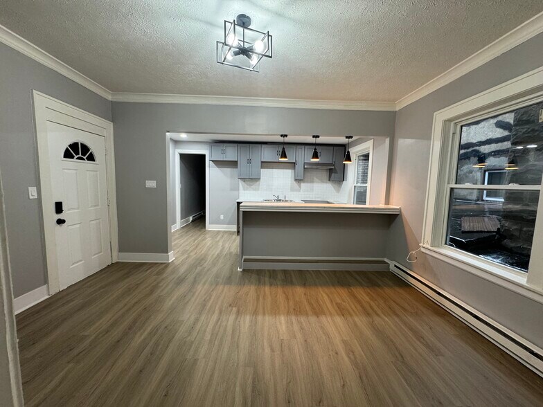 Main Living Area (Wide View)- Spacious living room with beautiful natural light and updated flooring - 898-902 Portland Ave