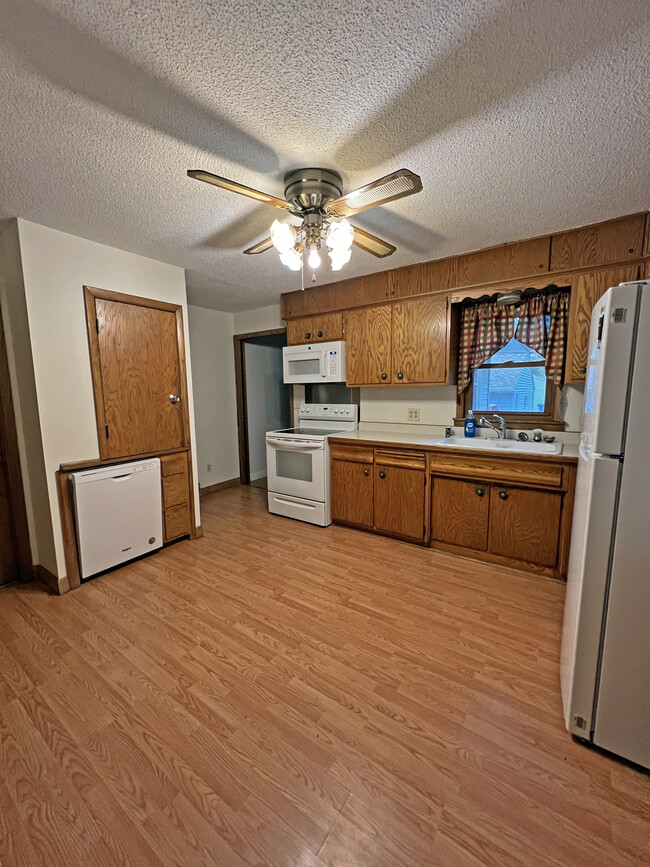 Kitchen with new dishwasher and microwave installed in 2021. - 1060 21st Ave SE