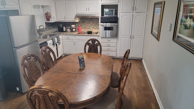 Kitchen with huge dining room table - 6585 Buckhurst Trl