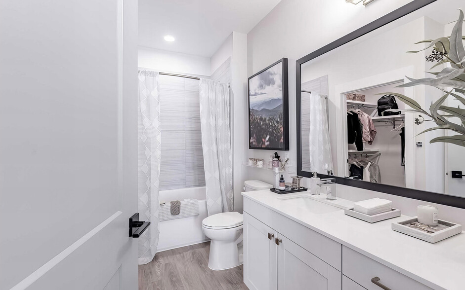 Full bathroom with a bathtub with tile backdrop - Novel Cary