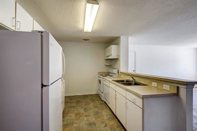 Nice kitchen with white cabinetry and all white appliances - Stonecreek