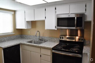 Building Photo - Condo unit featuring updated kitchen with ...
