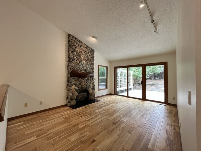 Building Photo - Spacious 3-Bedroom Home with Custom Stone Fireplace, Attached 2-Car Garage & Expansive Backyard i...