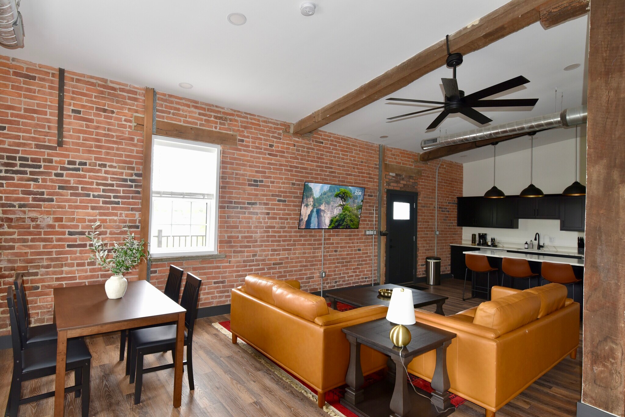 Living room is open concept. Tall vaulted ceilings with fans and spotligtsts throughout. - 101 W Broadway St