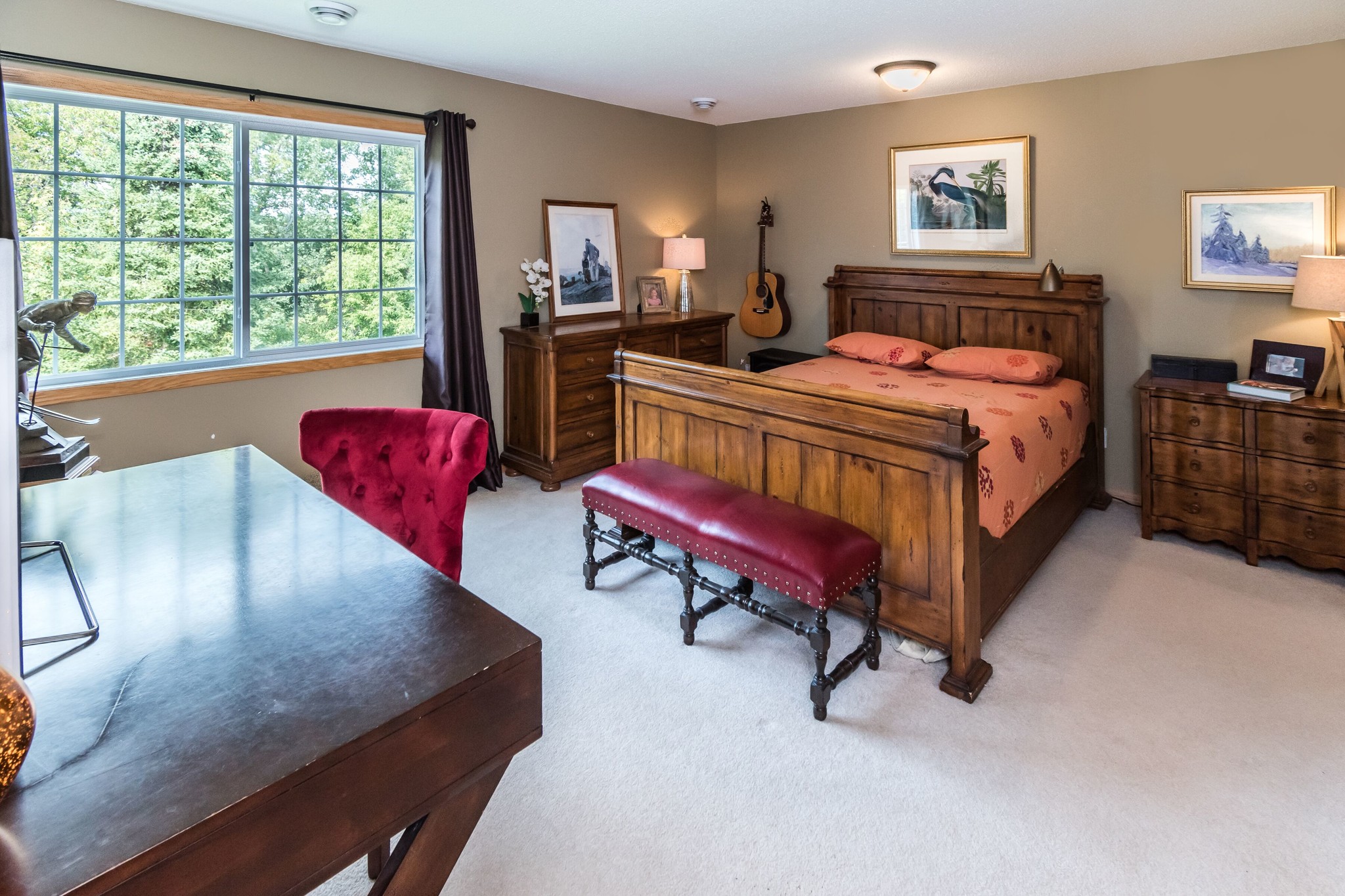 Large primary bedroom with walk-in closet and attached full bathroom. - 1102 Bergmann Dr