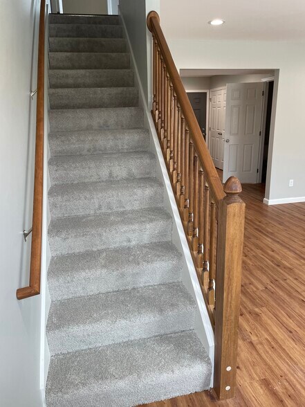 stairs to the left in living room - 1203 Remington Park Dr