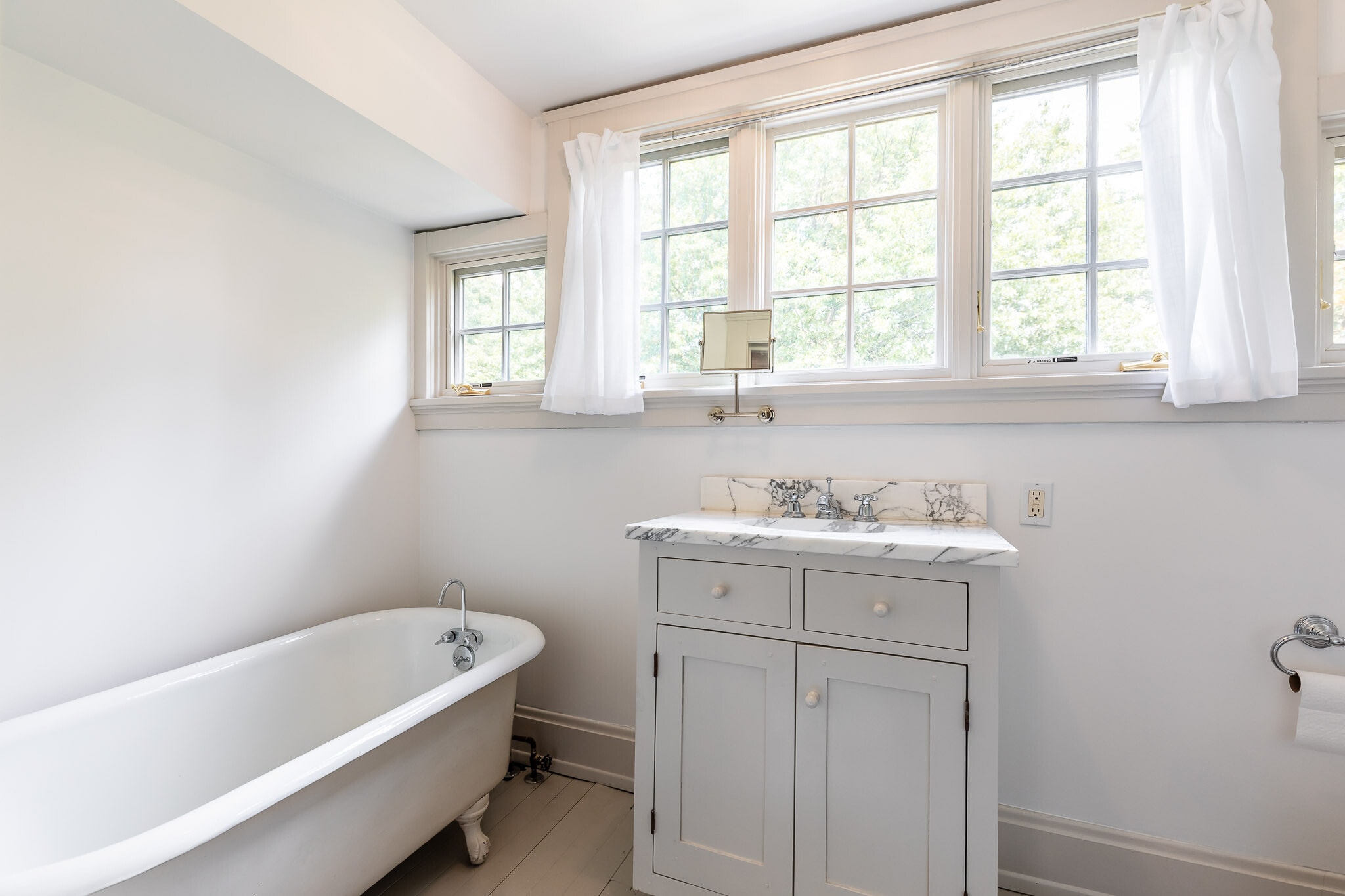 Bath 3 offers custom cabinets, marble and claw foot tub. - 4061 Beechwood Ave