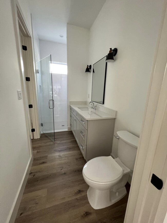 Full bathroom downstairs with tile all the way to the ceiling. - 114 Enchanted Way