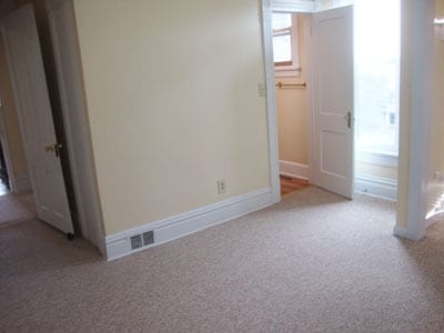 Front bedroom looking toward the bathroom door. Living room door is on your left. - 512 S Center St
