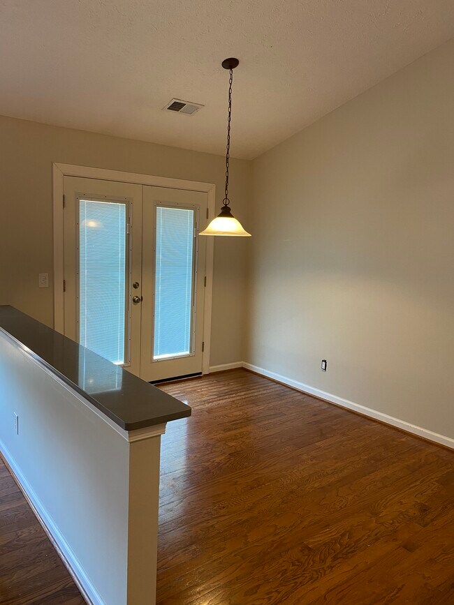 Eat-in area adjacent to kitchen, doors to deck - 709 Warmstone Ct