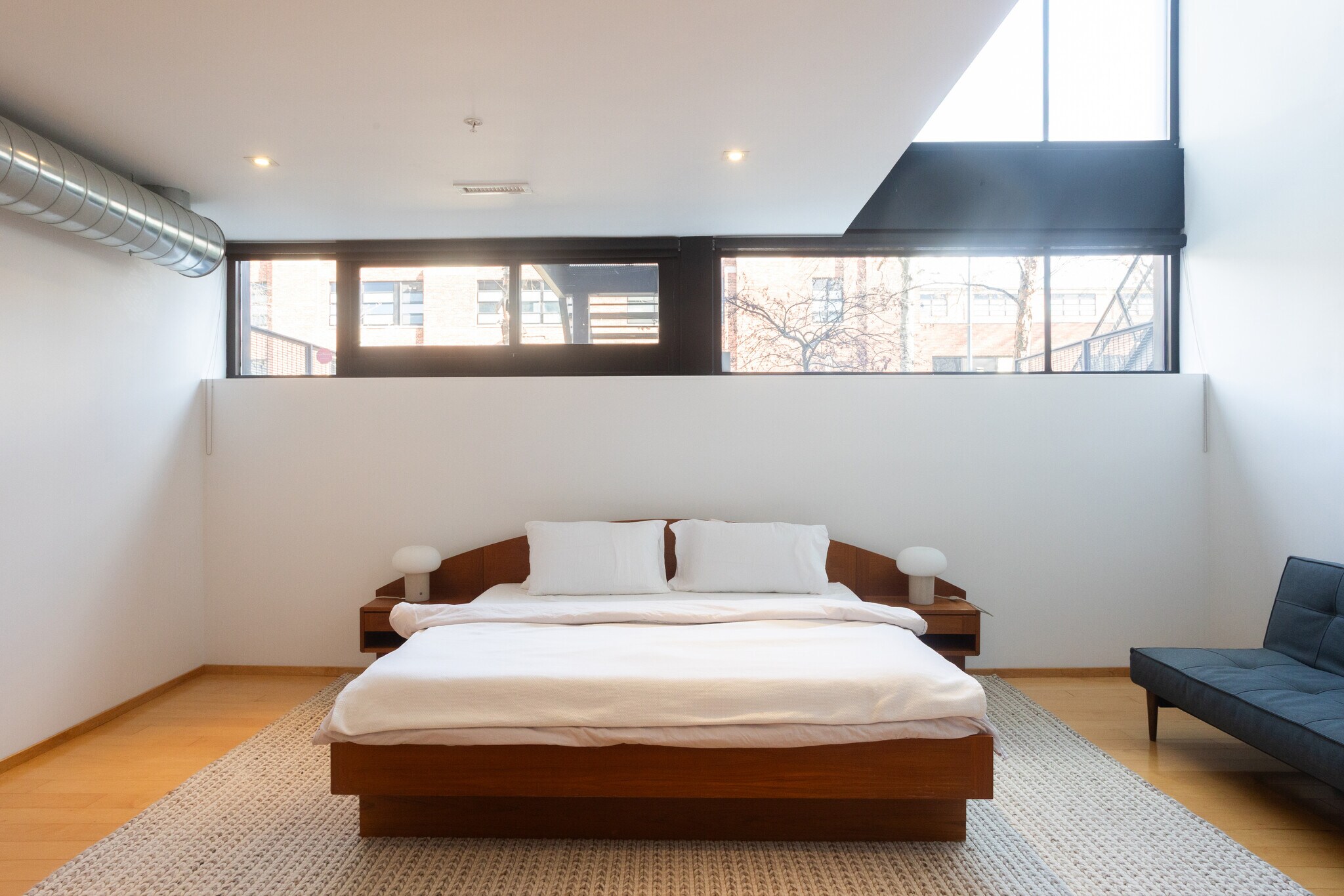 Spacious primary bdrm w/ shades (pictured w/ shades rolled up), king-size bed, R&B daybed & 65" TV - 2250 11th St NW