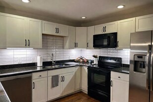 Exceptionally large kitchen for a two-bedroom townhome with eat-at counter and abundant cabinetry. - 524 Superior St