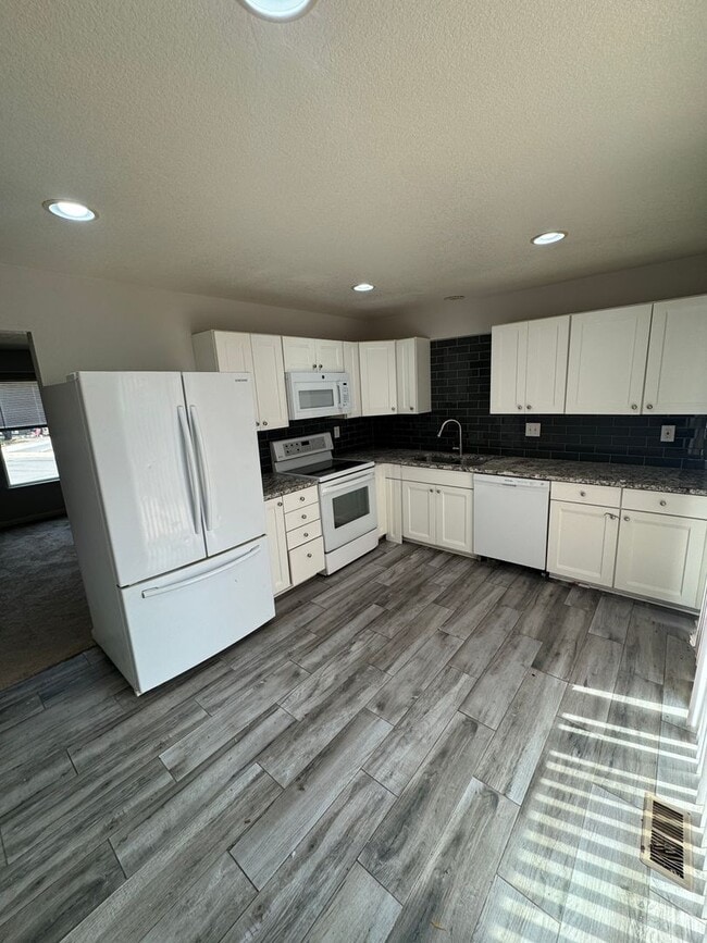 Building Photo - Welcome home to your updated 4-bedroom, 2 ...
