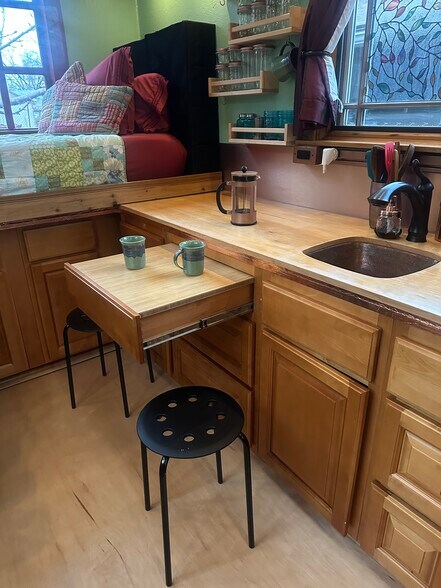 A tabletop can be added to the drawer and the stools pulled round to create a table for two. - 833 Valencia St