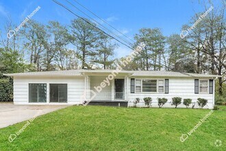 Building Photo - This Cozy 4 bedroom / 2 full bath and 2,09...