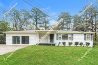 Building Photo - This Cozy 4 bedroom / 2 full bath and 2,09...