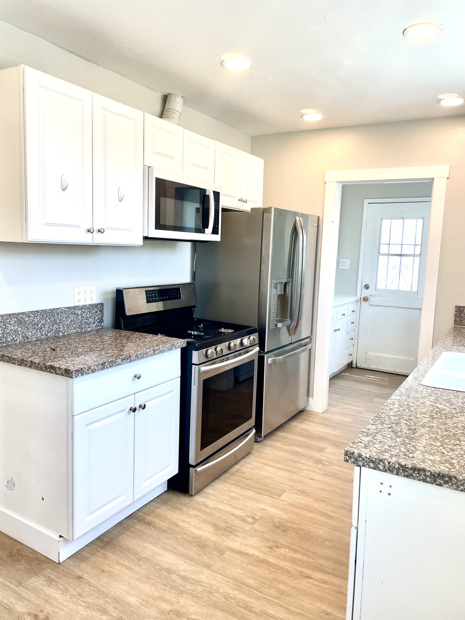 Kitchen with laundry room adjacent and exit to backyard - 10134 Memory Park Ave