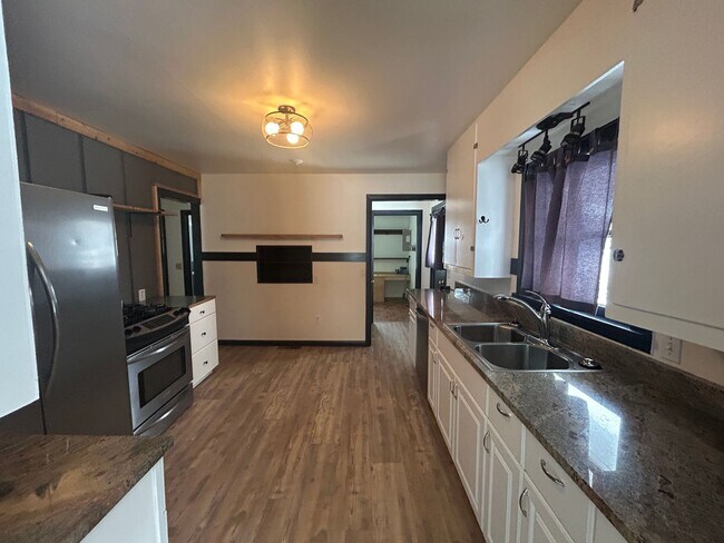 Building Photo - Bigfork Rodeo Farmhouse~ Fenced garden, greenhouse, garage, barn and shop!