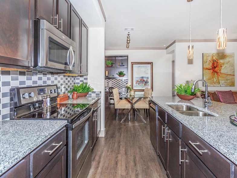 Kitchen with Granite countertops and island - Plantation Park