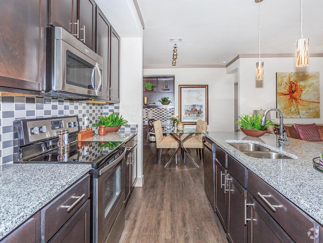 Kitchen with Granite countertops and island - Plantation Park