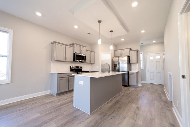 Building Photo - Elegant Home with Stone Fireplace, Kitchen Island and Designer Primary Suite