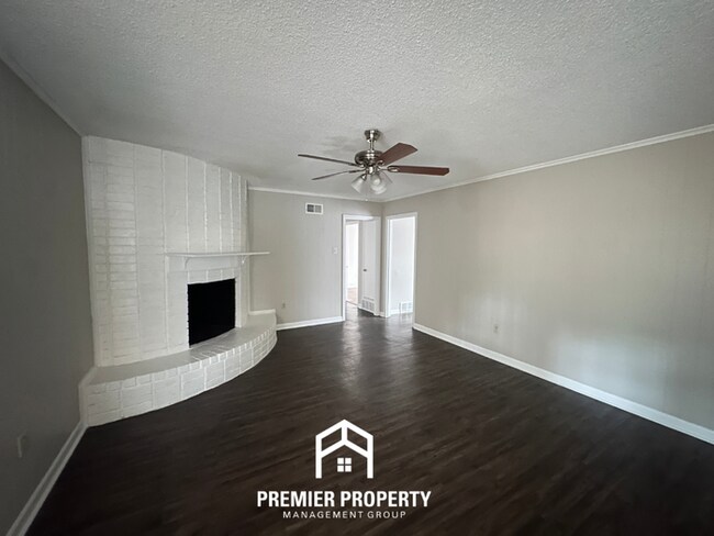 Building Photo - Charming 3BR Memphis Home | Rustic Brick Fireplace, Formal Dining & Fenced Backyard