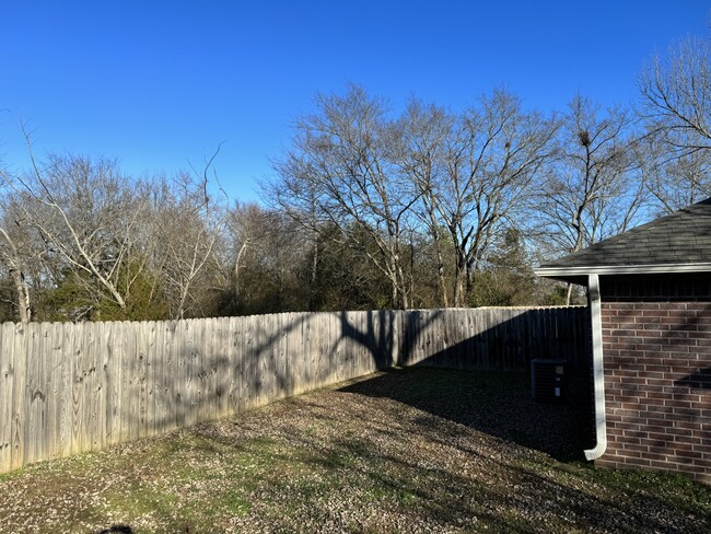 Partially fenced backyard. - 600 Petros Ave