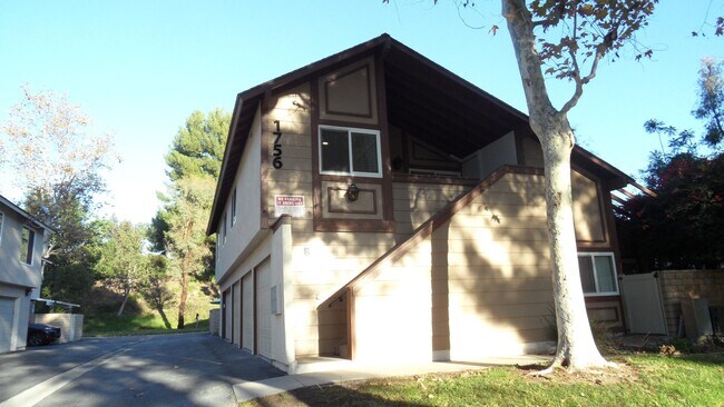 Building Photo - REMODELED 2BR; 1BA end unit condo w/ 1 car garage & 1 parking space